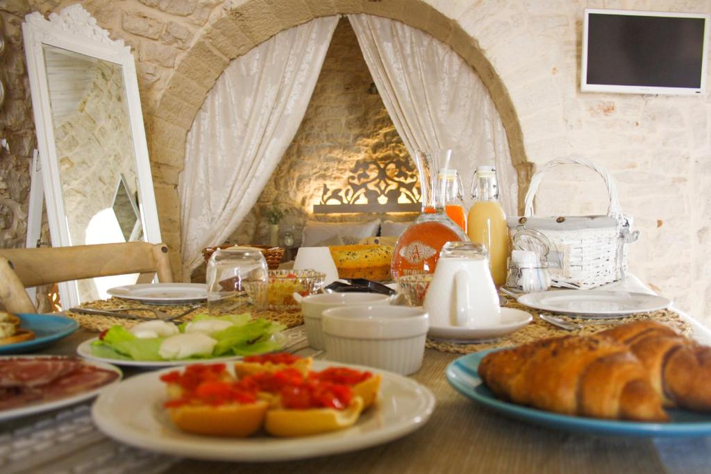 a table with plates of food and bread on it at EnjoyTrulli - Unesco Site in Alberobello