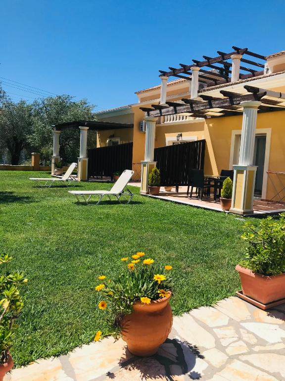a house with a yard with flowers in the yard at L'Eremo Luxury Apartments in Roda