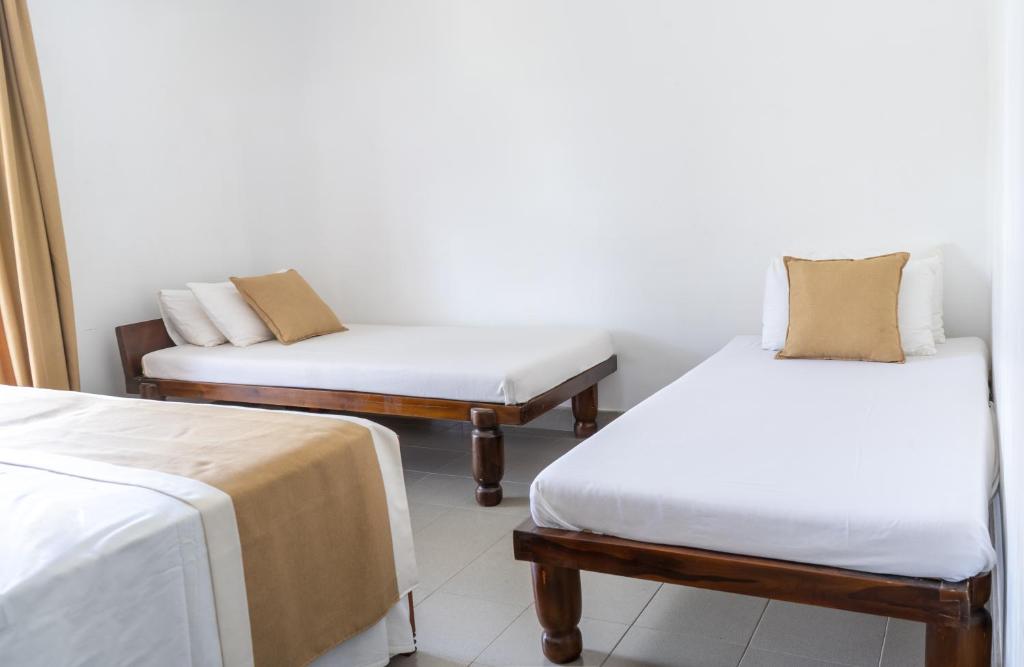 Postel nebo postele na pokoji v ubytování Villa Sarakkuwa