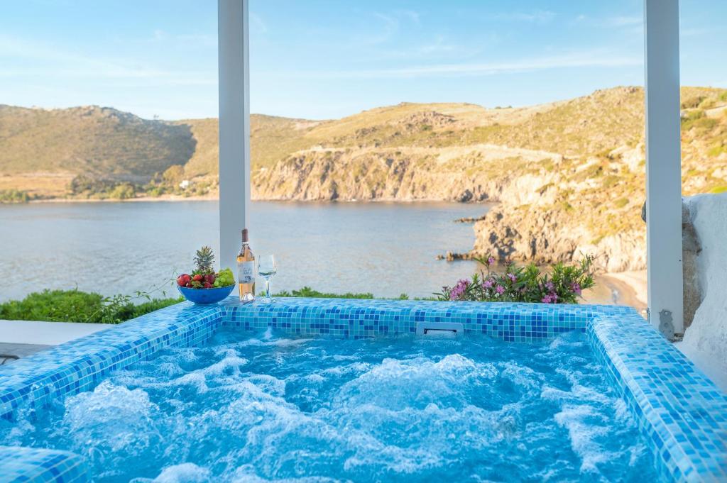a swimming pool with a view of the water at Eleftheria's Place in Patmos