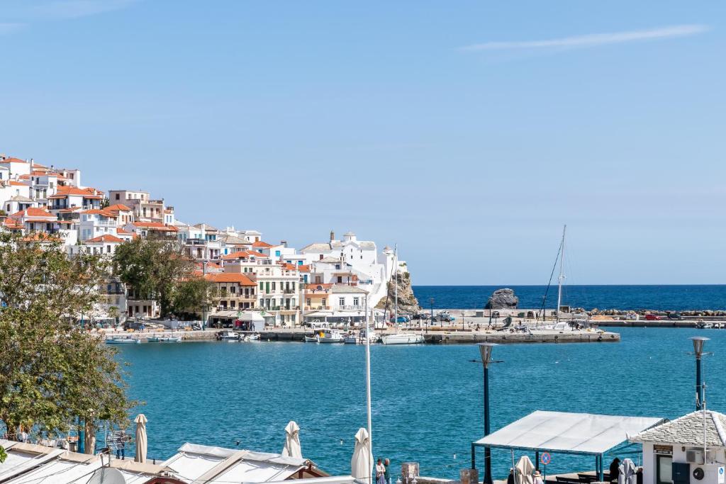 a view of a harbor with buildings and the water at Marialena Rooms in Skopelos Town