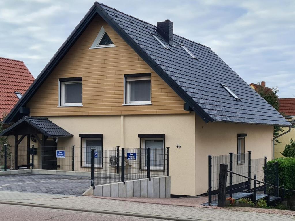 a house with a black roof at Ferienwohnung-Kormann in Schkopau