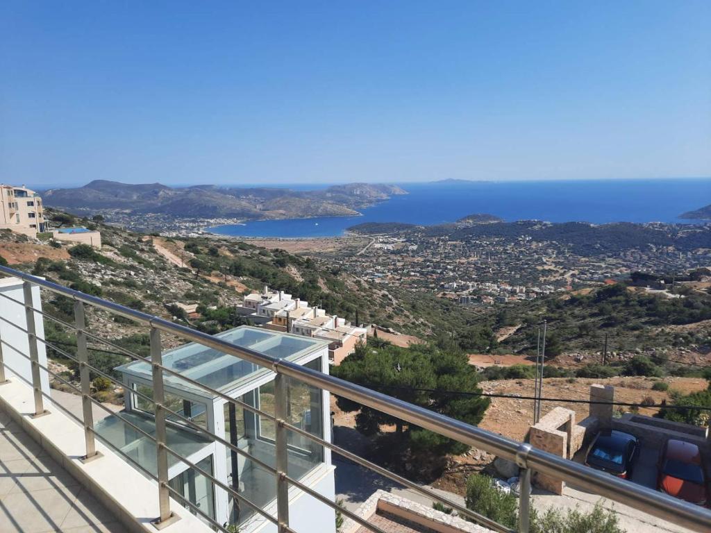 a view of the ocean from the balcony of a house at Viva B&B in Anavyssos
