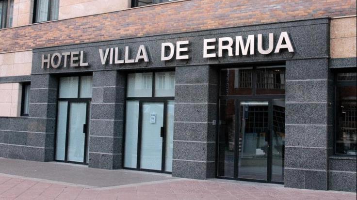 
a brick building with a sign on the side of it at Hotel Villa De Ermua in Ermua
