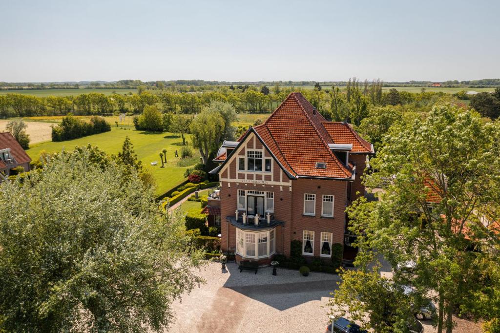 an aerial view of a large house with trees at Villa Magnolia in Oostkapelle