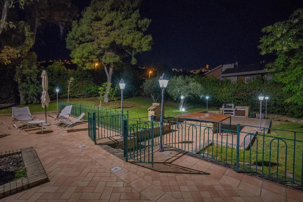 a patio with chairs and a table in a park at night at Villa Crisci Appartamenti Selene e Sirio in Vasto