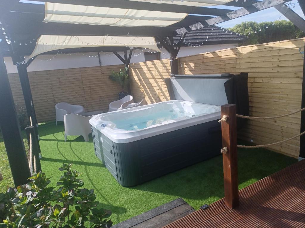 a hot tub sitting on the grass under an umbrella at Bubbles on the bay in Waterford