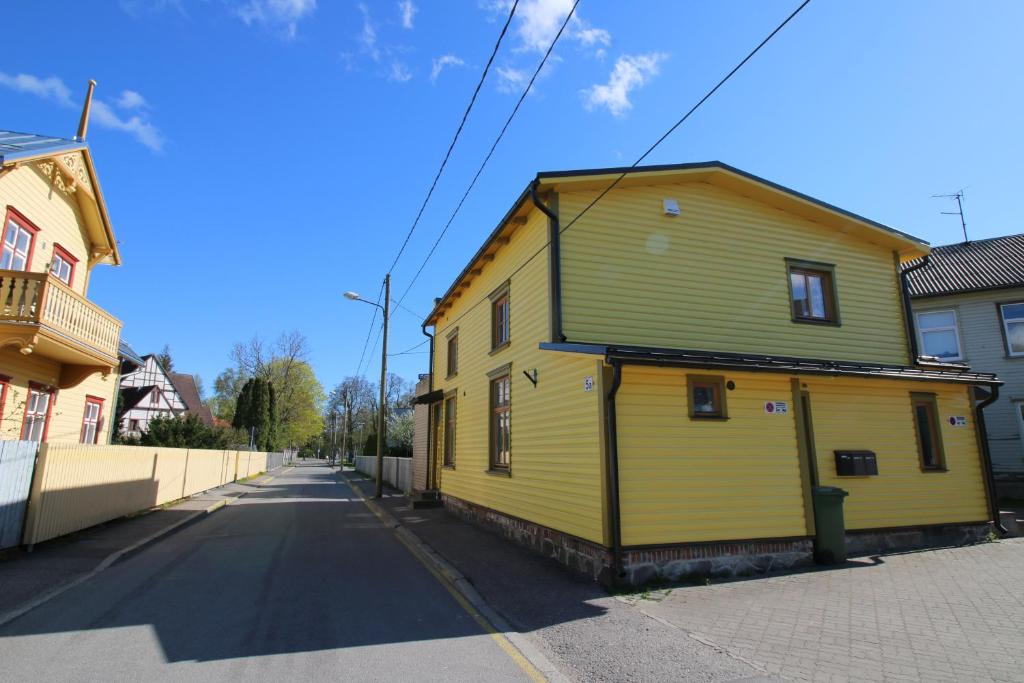 a yellow building on the side of a street at Sääse Apartments in Pärnu