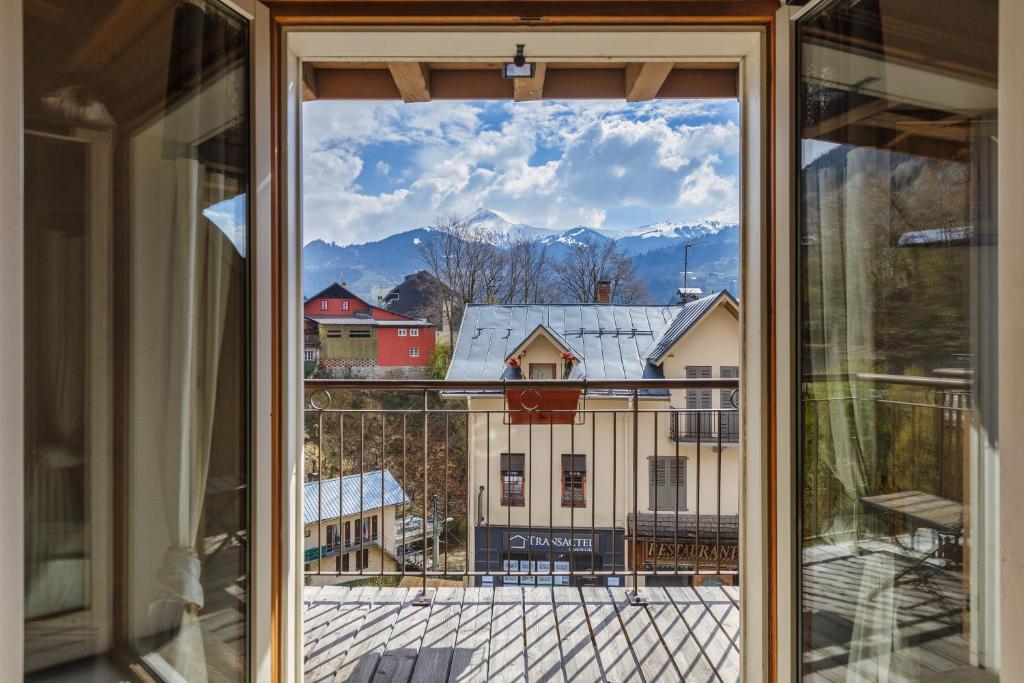a window with a view of a snow covered mountain at Charmant APT 3CH Centre Ville + Parking in Saint-Gervais-les-Bains