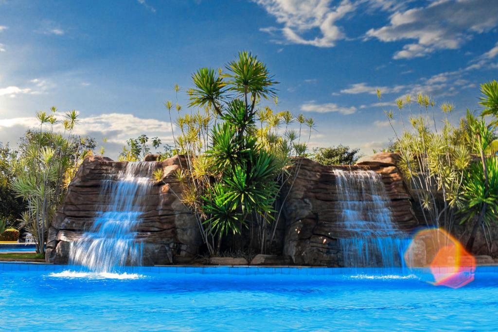 a waterfall in a pool at a resort at Ecologic Ville Resort - Oficial in Caldas Novas