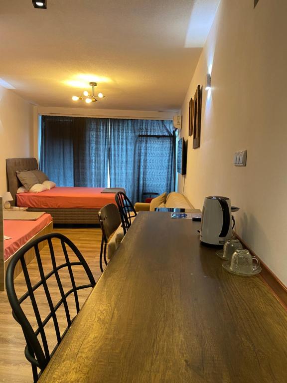 a room with a table and chairs and a bed at ZANI Hostel in Prizren