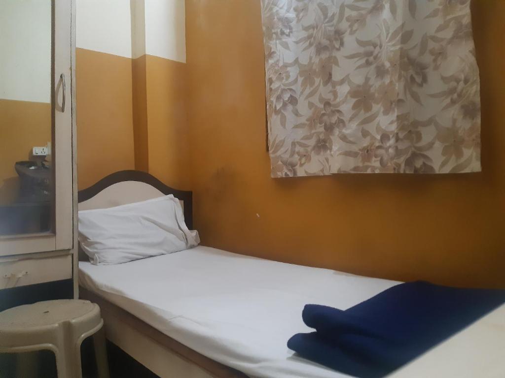 Postel nebo postele na pokoji v ubytování Greens Residency