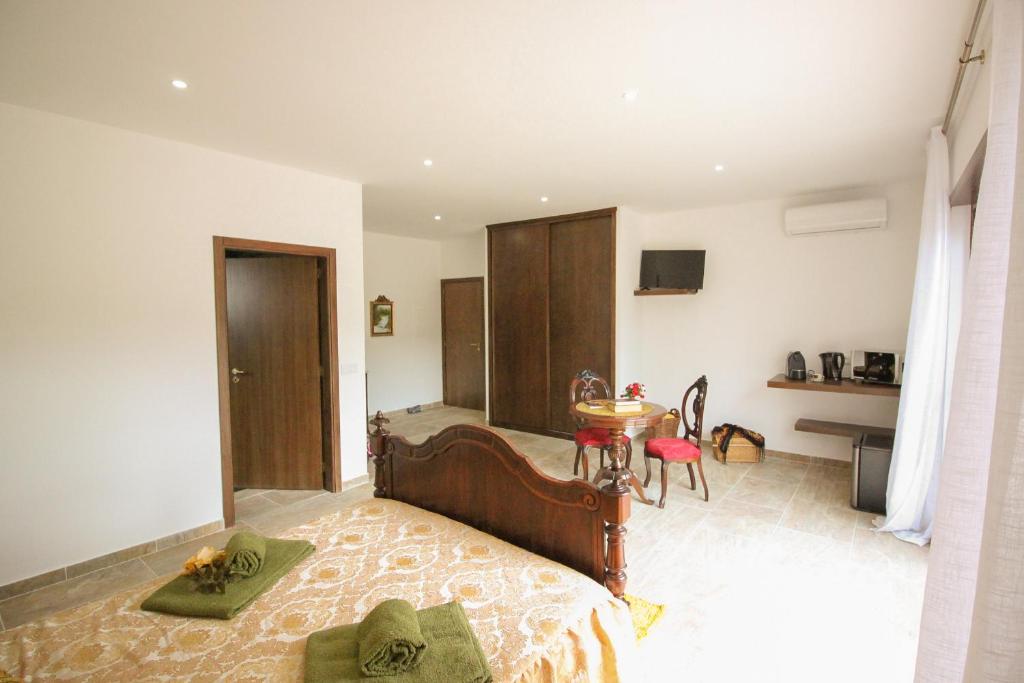 a bedroom with a bed and a table in it at Quinta dos Padrinhos - Suites in the Heart of the Douro in Lamego