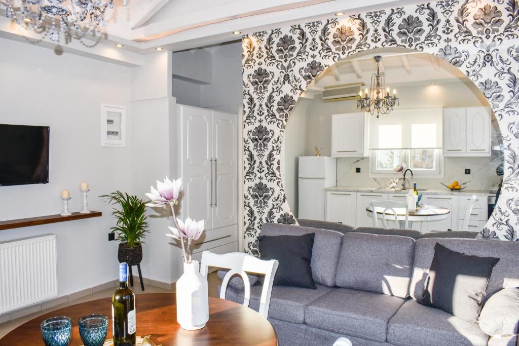 a living room with a couch and a table at Orianna Suites skiathos in Skiathos Town