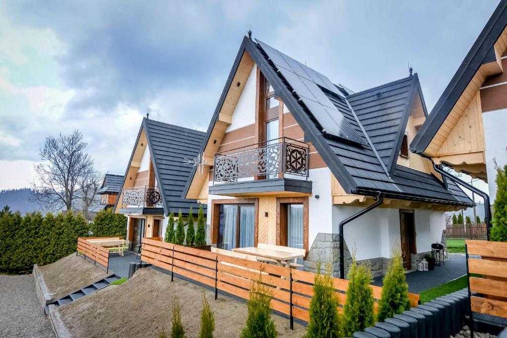 a house with a black roof at Tatras Residence in Poronin