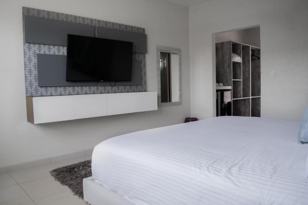 Ένα ή περισσότερα κρεβάτια σε δωμάτιο στο Hotel Aquetzalli