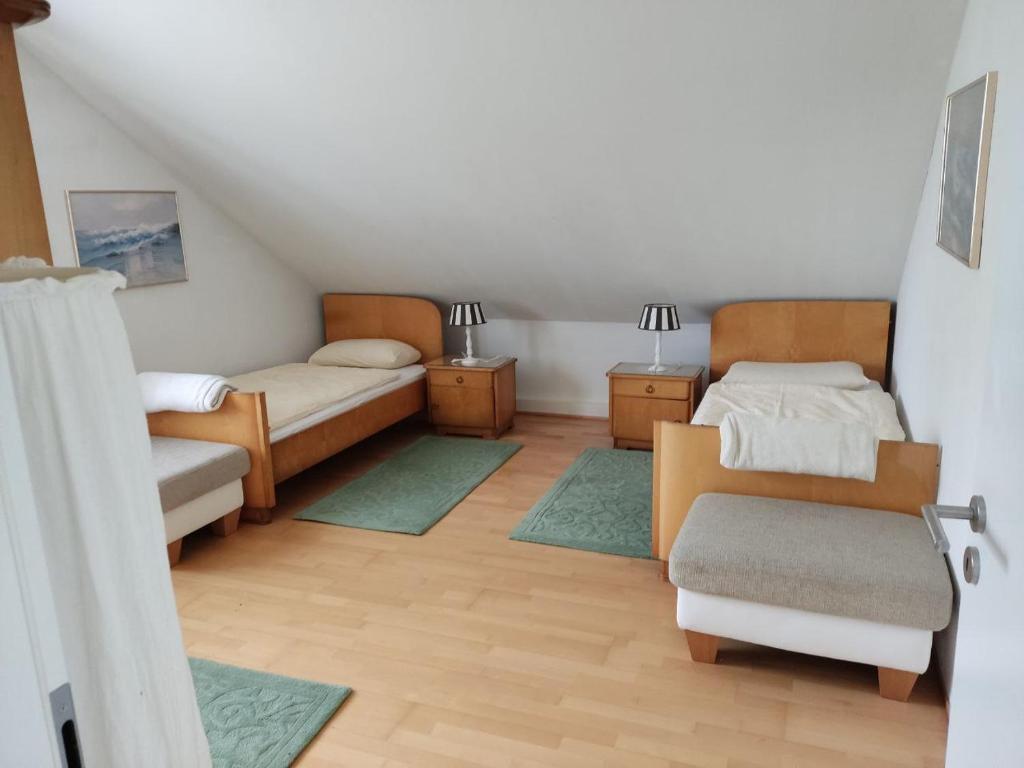 a room with two beds and two rugs at Unterkunft Mau in Rotenburg an der Wümme