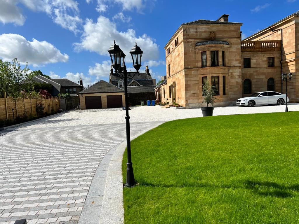 a street light in the grass in front of a building at Beautiful 4-Bed Villa in Glasgow in Glasgow