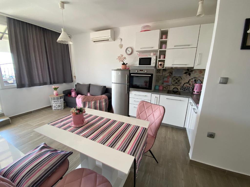 a kitchen and living room with a table and chairs at Golden View Penthouse in Zadar