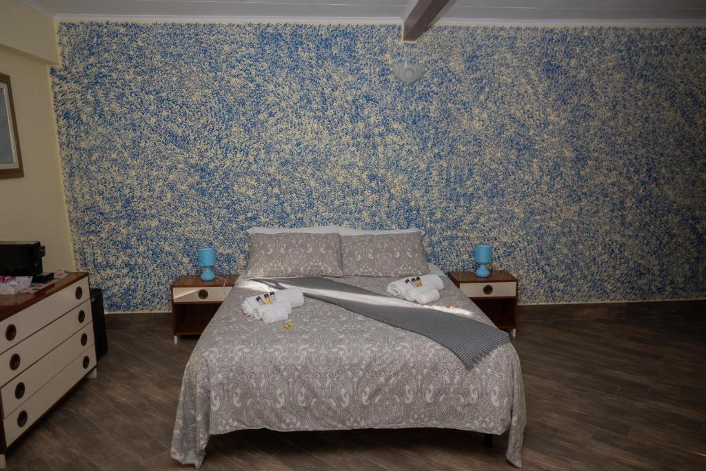 a bedroom with a bed with two mice on it at ACQUARIO in Pietrapertosa