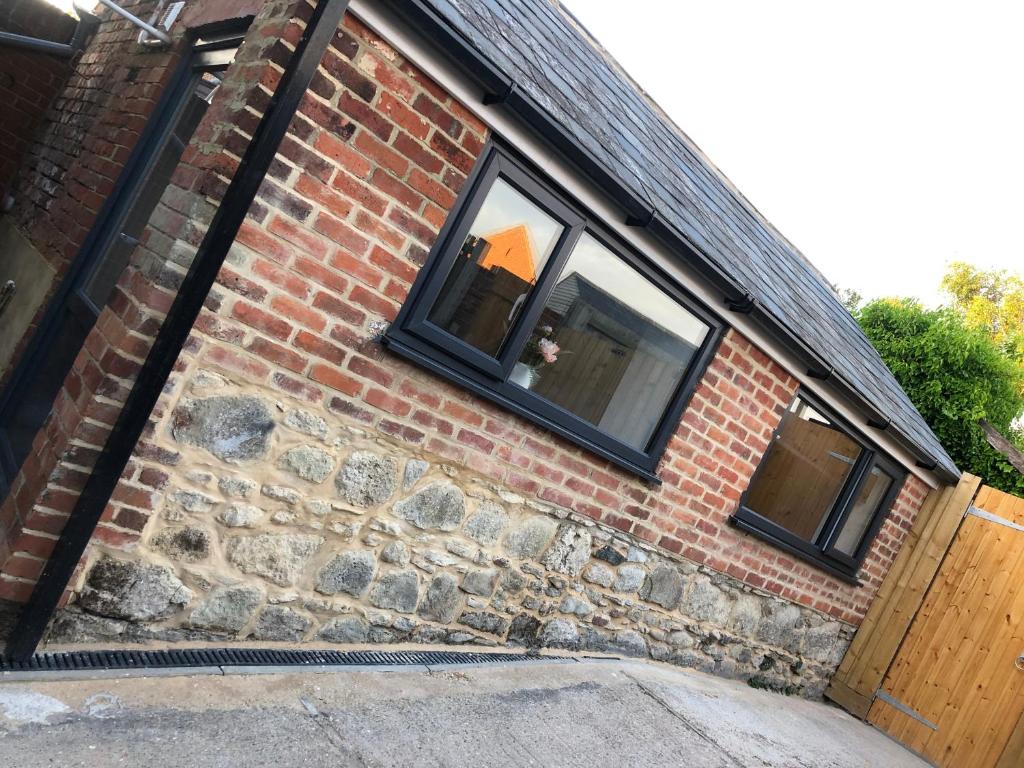 a brick house with two windows on the side of it at Exclusive Modern decorated 1 Bedroom Detached Studio in Newport