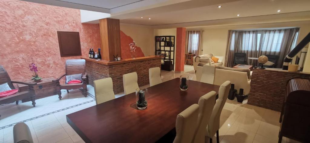a living room with a wooden table and a fireplace at CASUAL SUITES GANDIA CENTRO in Gandía