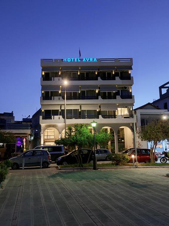 a building with a parking lot in front of it at Hotel Avra in Preveza