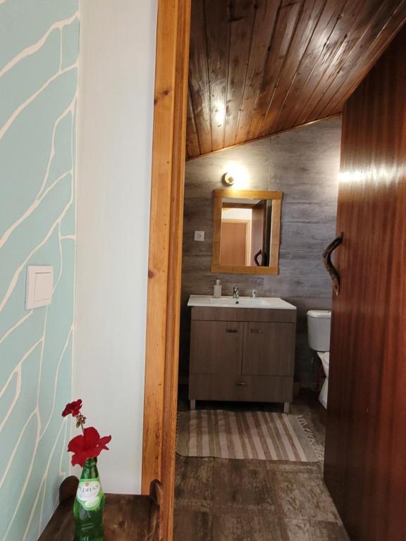 a bathroom with a sink and a mirror at The Handmade House Azores in Porto Formoso