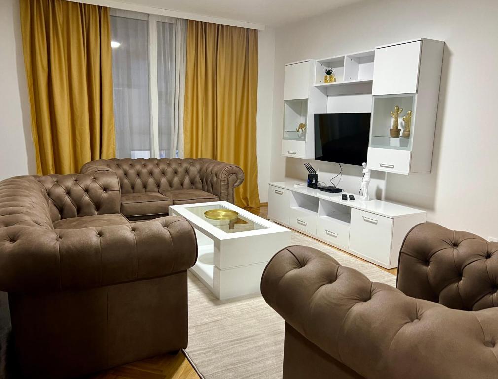 a living room with two couches and a television at Alex Apartment in Bar