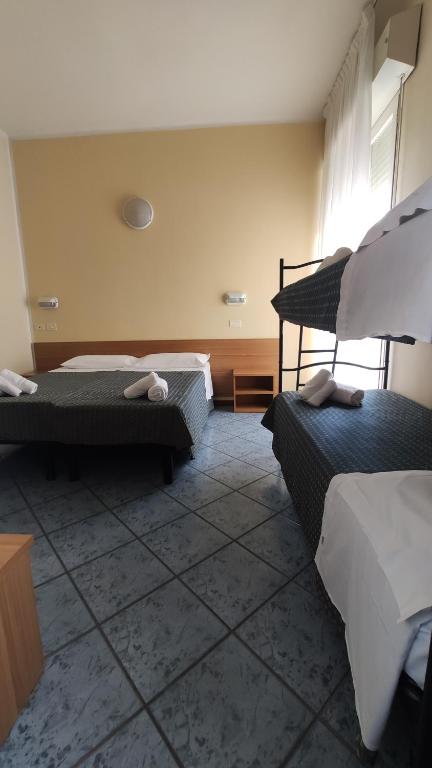 Postel nebo postele na pokoji v ubytování Hotel Corona