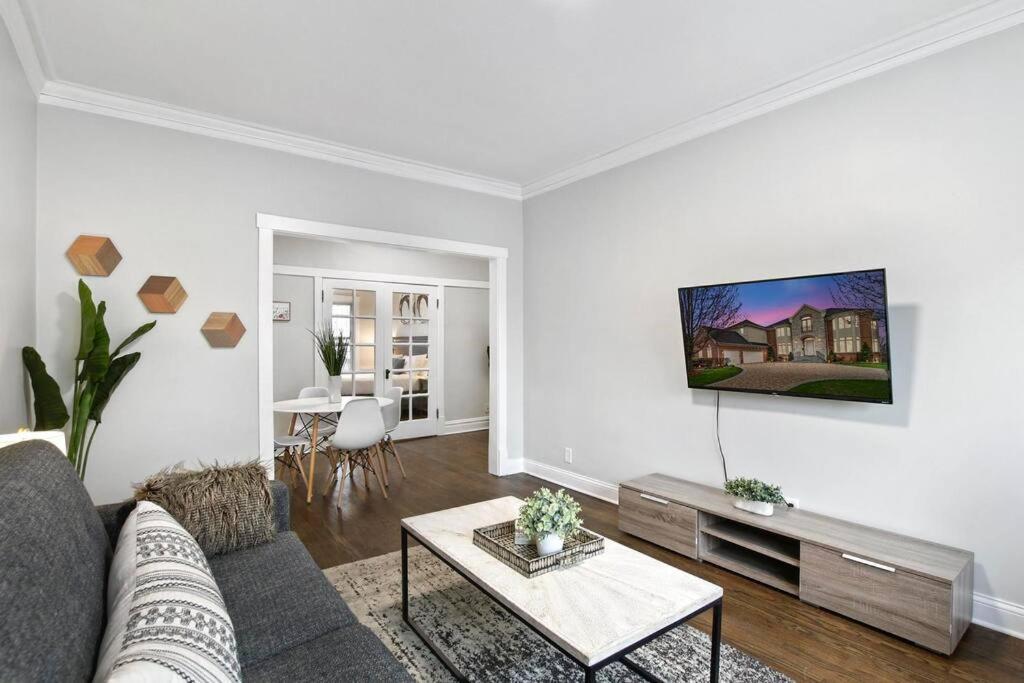 a living room with a couch and a table at 2BR Stylish Apartment in Avondale close to Shops - Roscoe 1W in Chicago