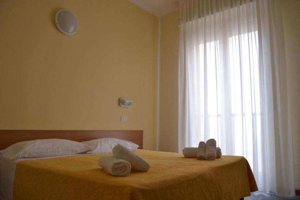 Postel nebo postele na pokoji v ubytování Hotel Corona
