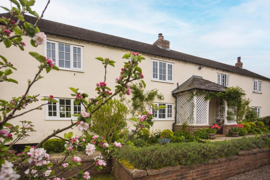 a house with flowers in front of it at Mulsford B&B in Malpas