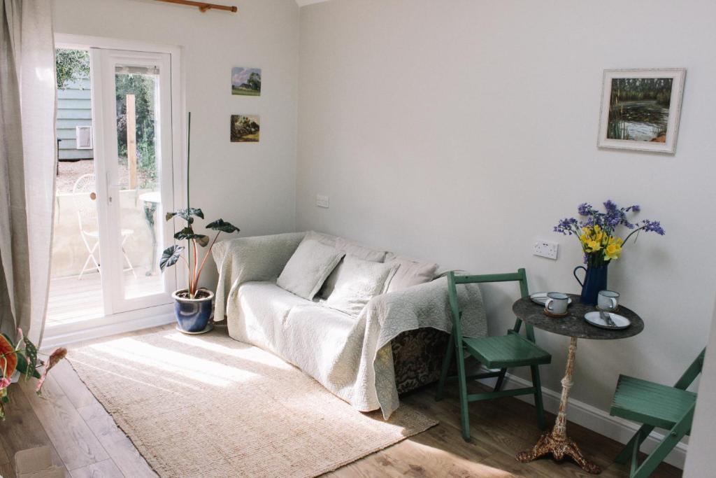 a living room with a couch and a table at Field View Lodge in Niton