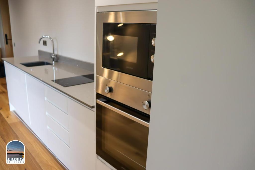 Kuchyň nebo kuchyňský kout v ubytování Oban Bay Apartments