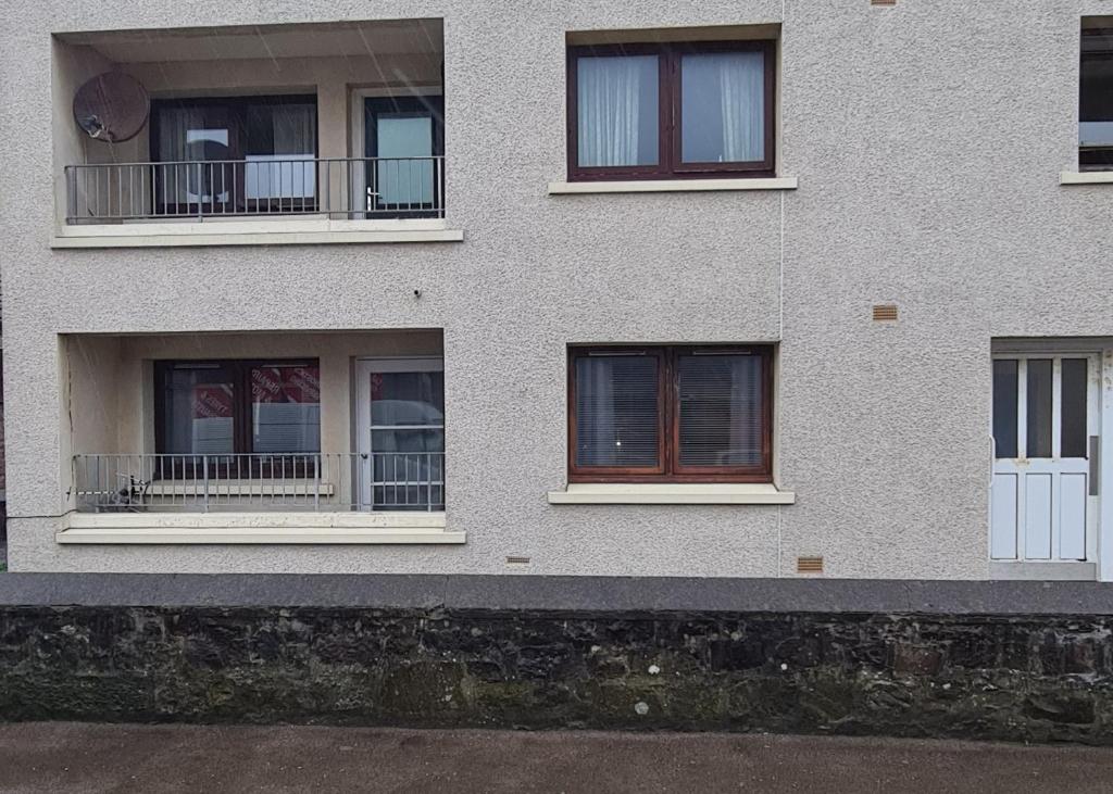 a facade of a building with several windows at Beautiful 2-Bed Apartment in Campbeltown in Campbeltown