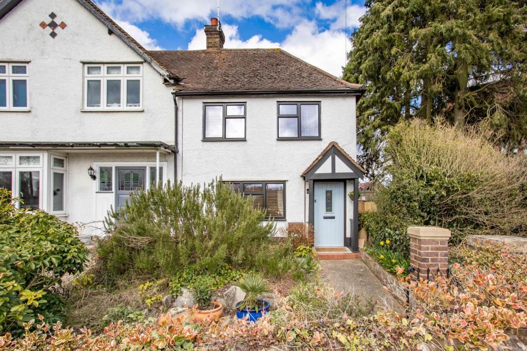 a white house with a blue door at Stunning character 2bed Cottage in St Albans Wifi in Saint Albans