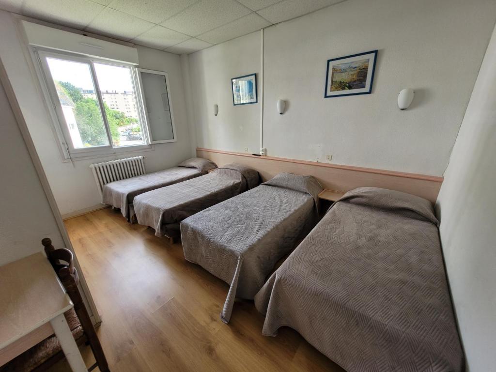 Postel nebo postele na pokoji v ubytování Hôtel Marquette