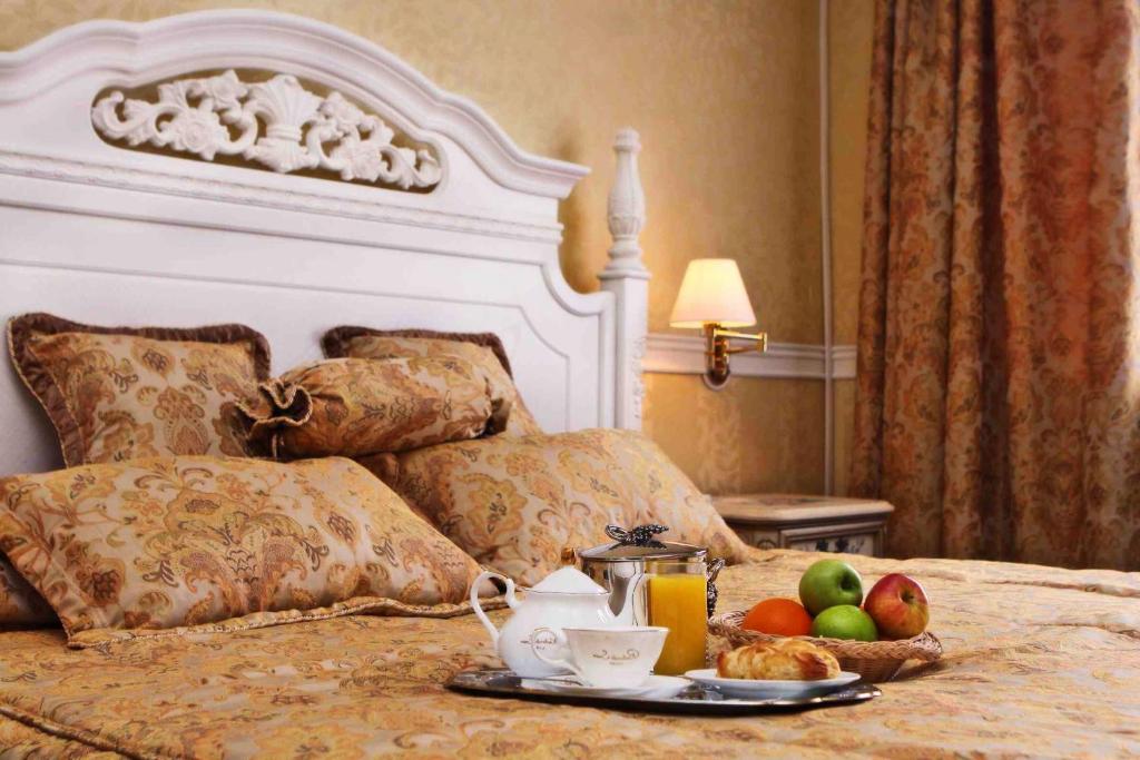 a tray of fruit sitting on top of a bed at Bayangol Hotel in Ulaanbaatar