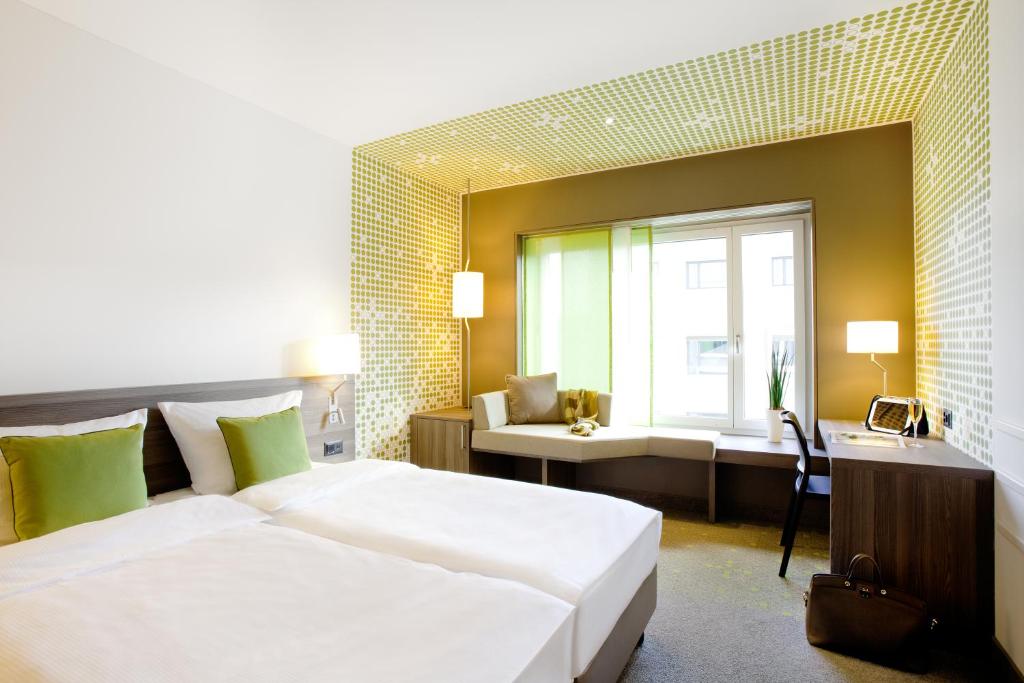 Postel nebo postele na pokoji v ubytování Vienna House by Wyndham zur Bleiche Schaffhausen