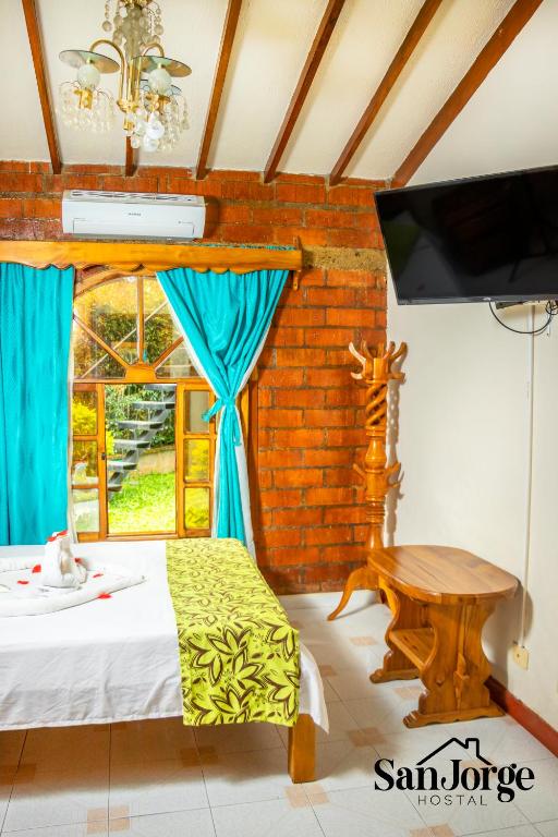 Postel nebo postele na pokoji v ubytování Hostal San Jorge
