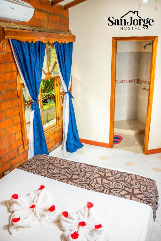 Postel nebo postele na pokoji v ubytování Hostal San Jorge