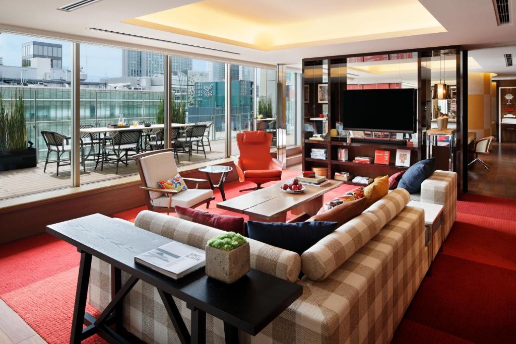 a living room with a couch and a television at Hyatt Centric Ginza Tokyo in Tokyo