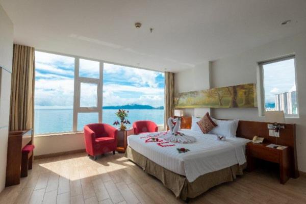 a hotel room with a bed and a large window at Nha Trang Wonderland Hotel in Nha Trang
