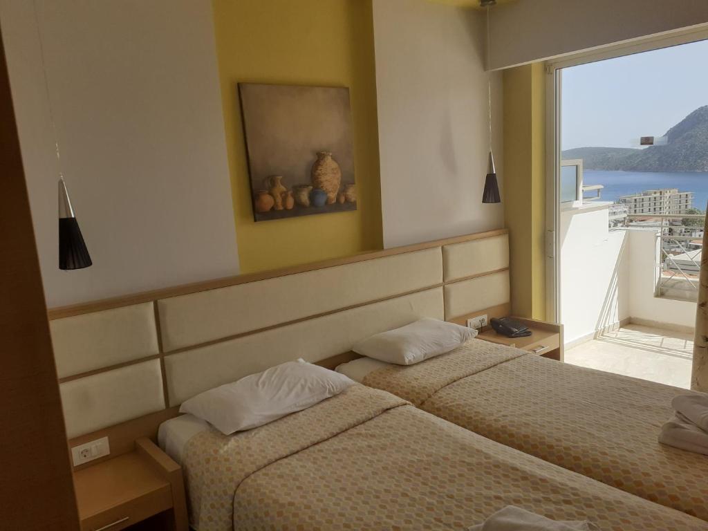 A bed or beds in a room at Hotel Apartments Panorama