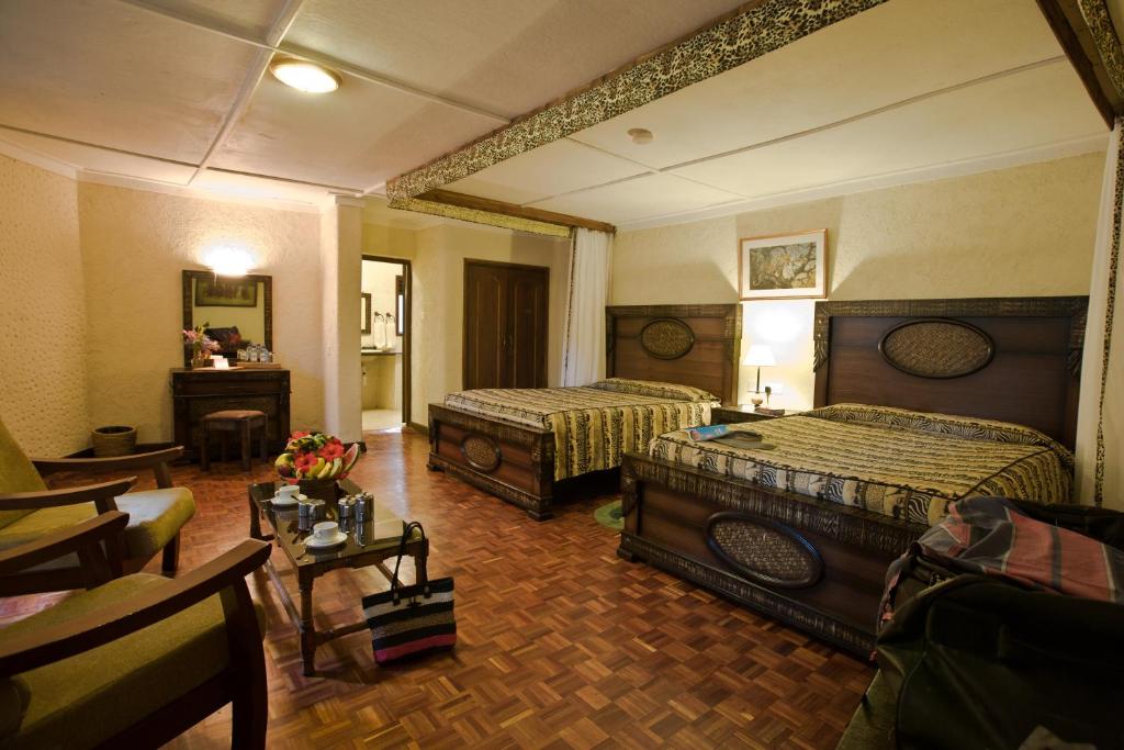 Postel nebo postele na pokoji v ubytování Masai Mara Sopa Lodge