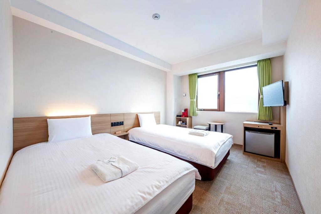Postel nebo postele na pokoji v ubytování Hotel Meldia Shijo Kawaramachi Annex