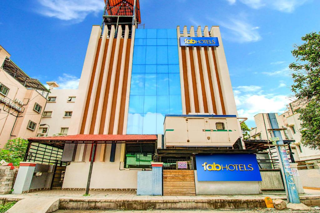 a building with a clock tower in front of it at FabHotel Emara Grand in Bangalore