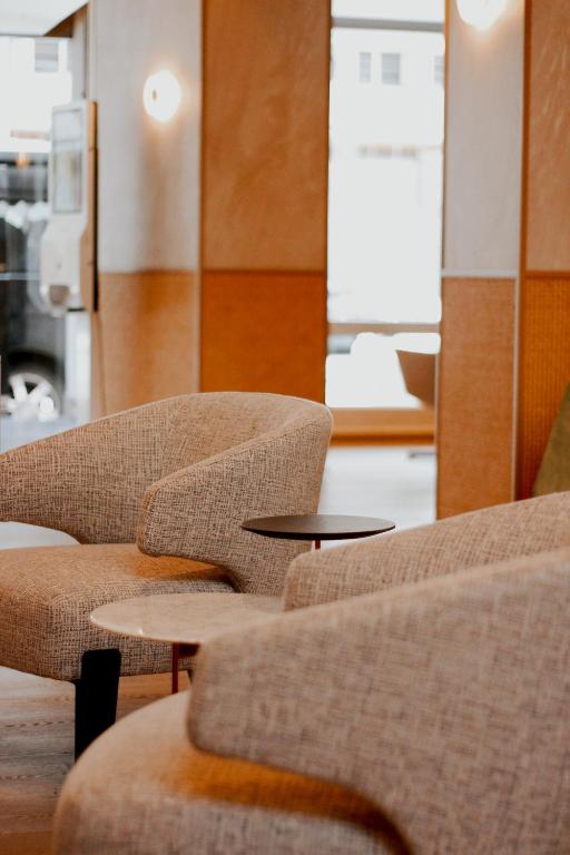 two chairs and a table in a room at The Brunei Hotel in Bandar Seri Begawan