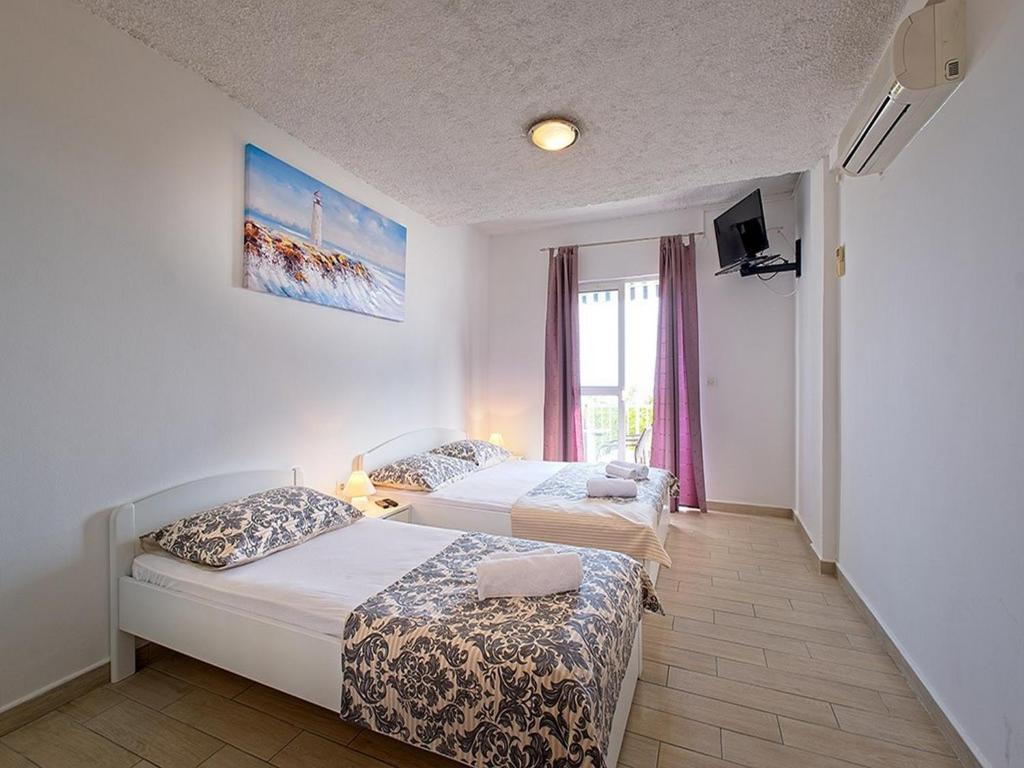 Posteľ alebo postele v izbe v ubytovaní Apartments Grljević